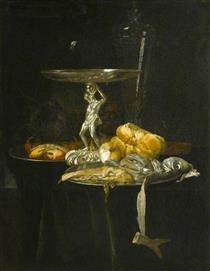 Still Life of a Silver Tazza with a Wine Glass, Crab, Herring, Bread and Onion on Pewter Dishes with Grapes Arranged on a Ledge - Виллем Ван Алст