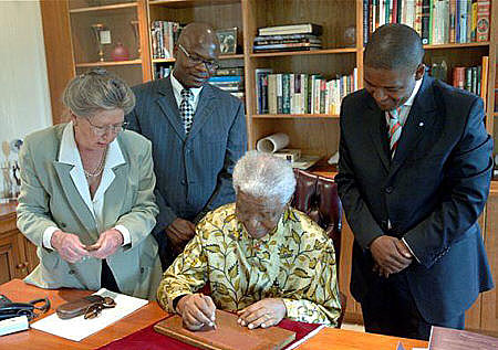 Signing with Nelson Mandela - MAUREEN QUIN